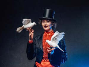 smiling-female-magician-with-two-white-little-dove